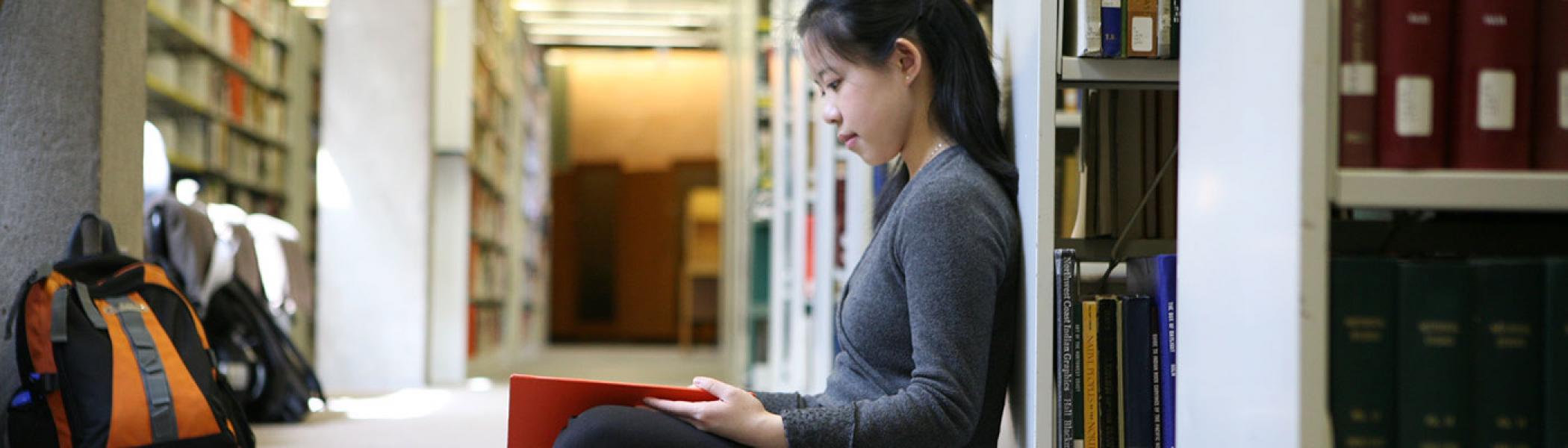 A student studying on the floor