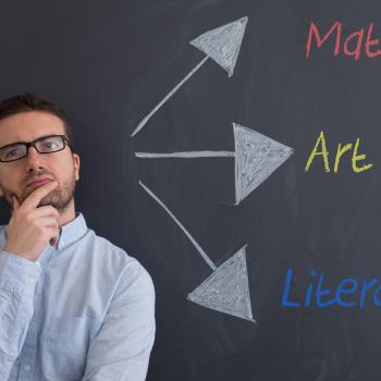 Teacher in front of blackboard with arrows pointing to subject names
