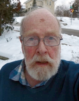 Ian Sandeman looking at the camera outside in winter with snow on the ground.